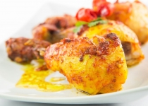 Tandoori chicken in a plate over white background